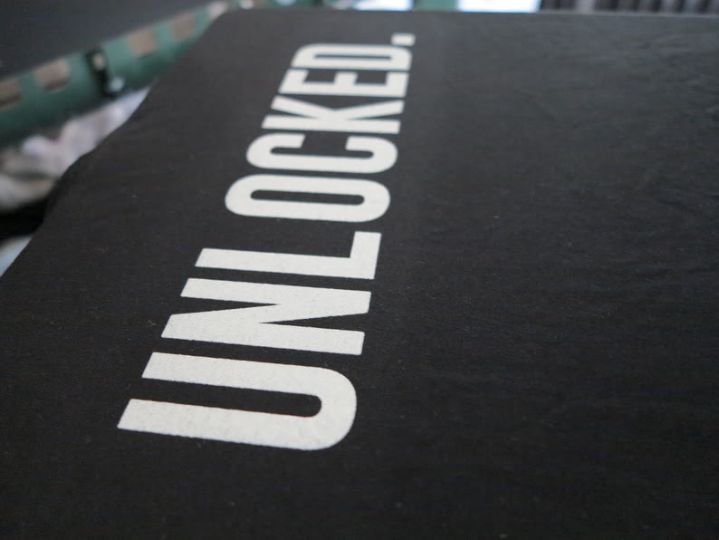 Marquage sérigraphié blanc épais sur un t-shirt noir, tirage Adidas Unlocked